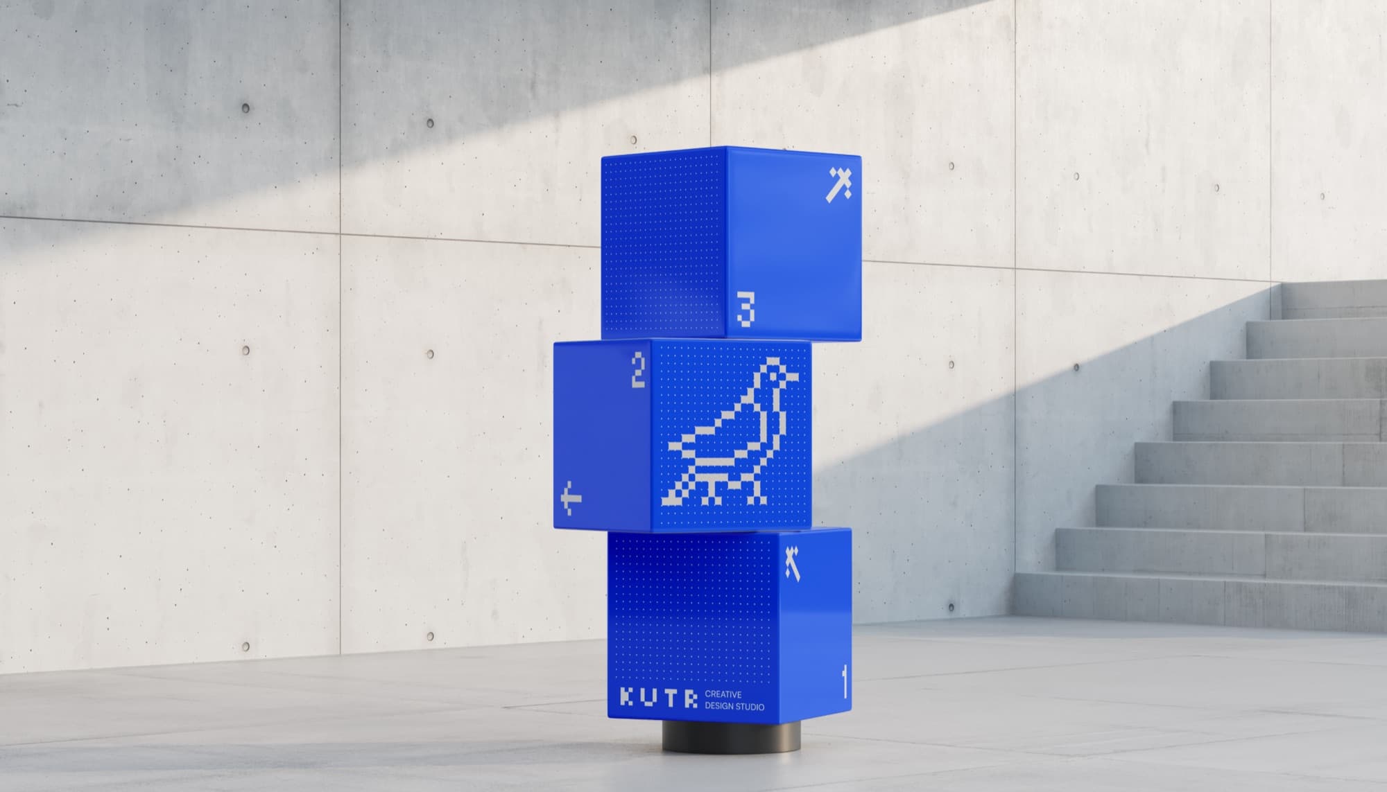 Three blue cubes stacked into a sculpture, the pixel bird across their faces.